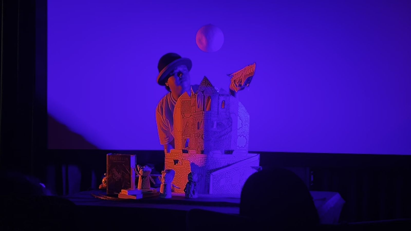 Wasu under blue light beside a paper castle, Untold Story at Sala Saneha